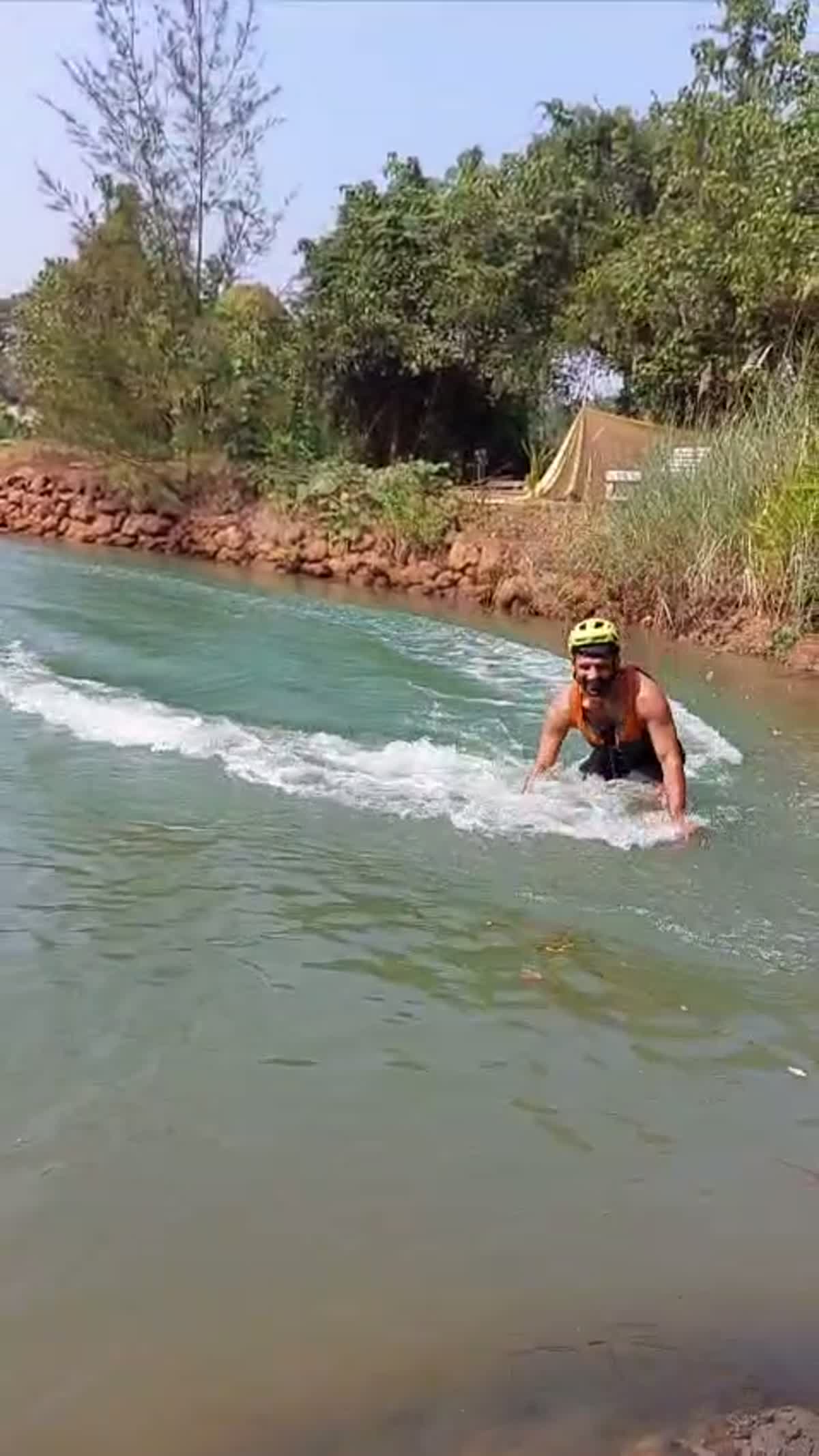 Wakeboarder carving across Om Lake, Arambol